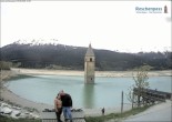 Archived image Webcam Lake Resia and the symbol of Venosta Valley 13:00