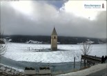 Archived image Webcam Lake Resia and the symbol of Venosta Valley 13:00